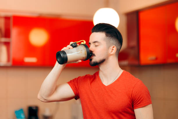 istock Man with Healthy Protein Energy Booster Shake in the Kitchen 1129524103