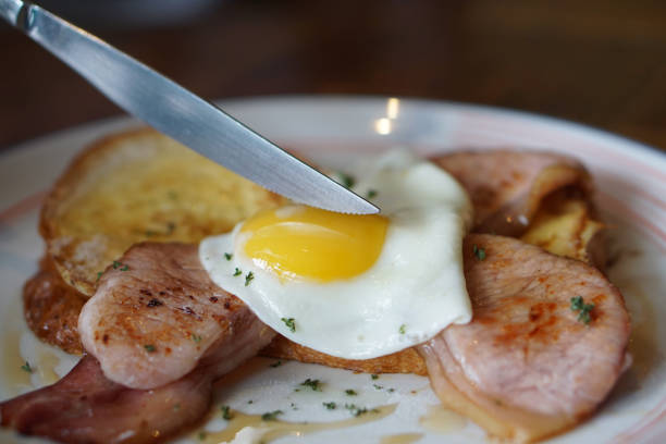 French Toast with back bacon and a sunny side up egg, topped with maple syrup, Delicious homemade breakfast concept.