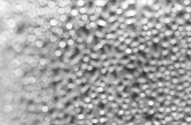 istock Blurred background of drops on the bottle wall. Blurred lights garland. Texture 1129530898