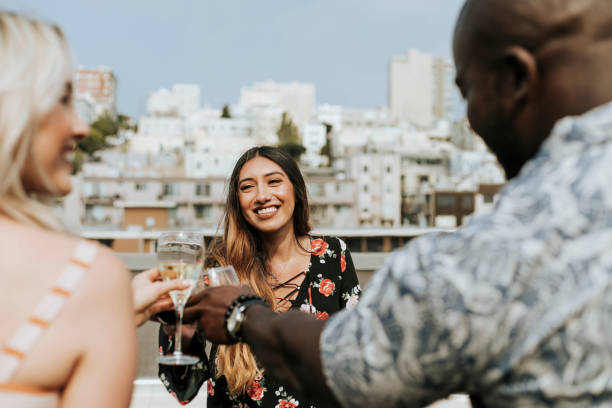 istock Cheerful friends toasting at a rooftop party 1129531323