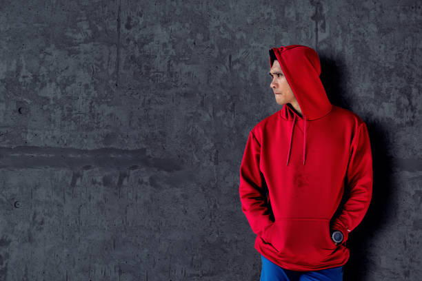 sport man in red hood with dark cement background. - stripped shirt imagens e fotografias de stock