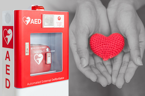 AED or Automated External Defibrillator first aid help giving life heart concept