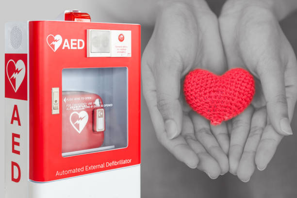 AED or Automated External Defibrillator first aid help giving life heart concept AED or Automated External Defibrillator first aid help giving life heart concept defibrillator photos stock pictures, royalty-free photos & images