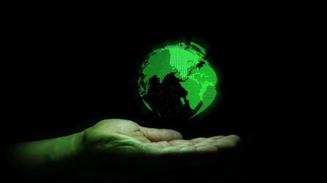 Green hologram the earth shape rotation on human hand with black background , technology for future concept