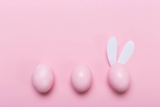 istock Pink easter eggs in nest on pastel color background with space. Concept 1129550165