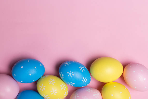 istock Colorfull easter eggs in nest on pastel color background with space. Concept 1129550169