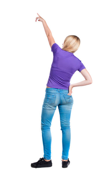 istock Back view of  pointing woman. 1129550262