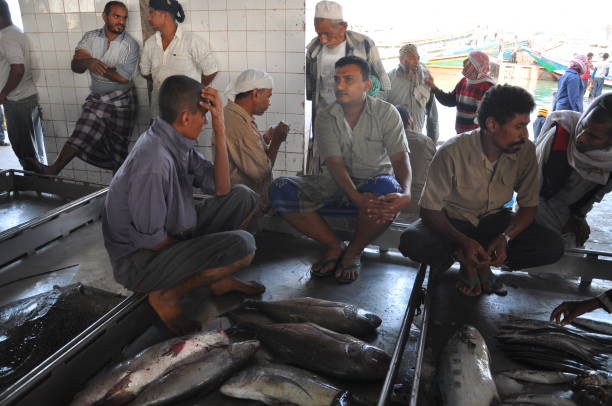 Al Hudaydah, Yemen - December, 31, 2010: Unidentified Yemeni fisherman demonstrates catch of the day at the fish market in Al Hudaydah, Yemen.