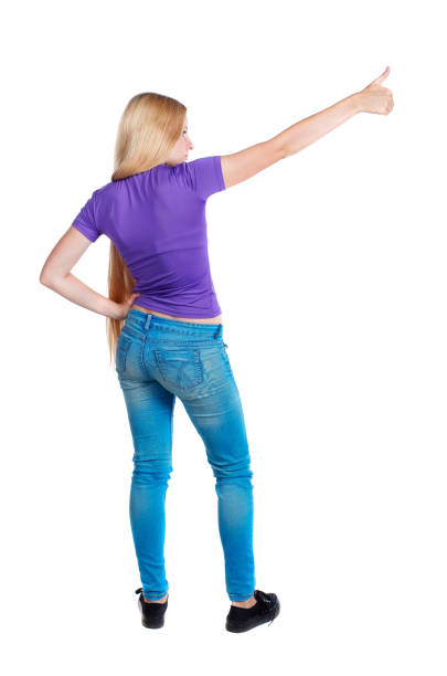 istock Back view of  pointing woman. 1129552211