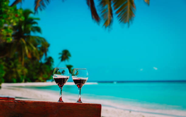 istock two wine glasses on tropical sand beach vacation 1129552830