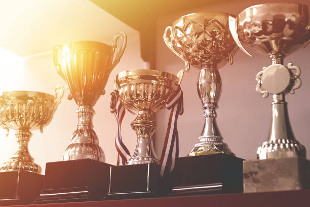 Group of Trophies on Shelf Group of trophies on shelf. award ribbon photos stock pictures, royalty-free photos & images
