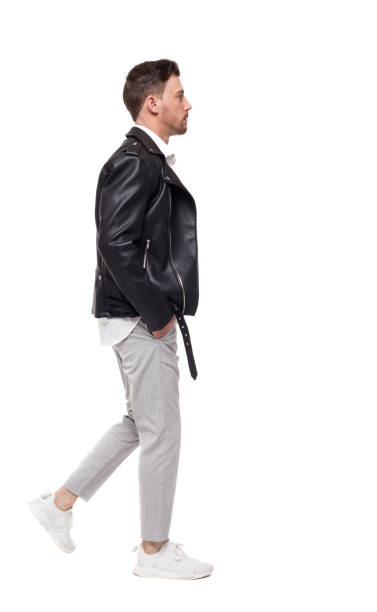 istock Side view of going  handsome man in a leather jacket and trouser 1129554206
