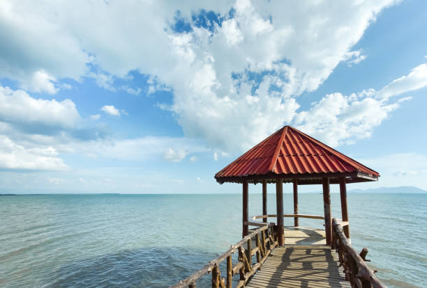 istock Little pavilion in the sea cloudy background. 1129558534