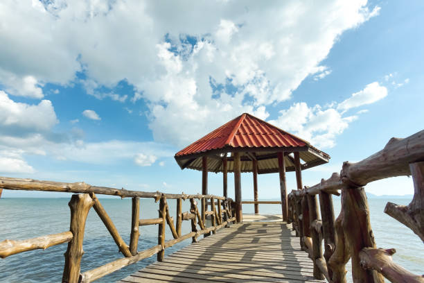 istock Little pavilion in the sea cloudy background. 1129558550