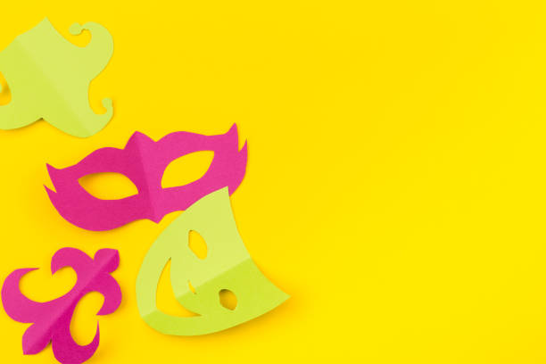 istock cut out colored paper figures for the holiday Mardi Gras, colour background 1129558758