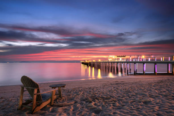 istock Wooden chair on beach. 1129558845