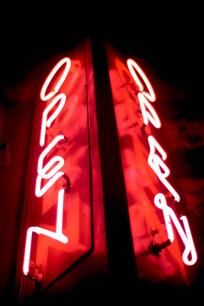 istock Glowing neon open sign in red and white letters 1129559778