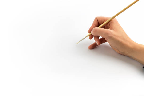 istock Hand holding brush, isolated on white background 1129565142