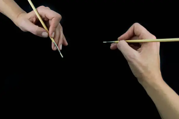 Hand holding brush, set isolated on wblack background