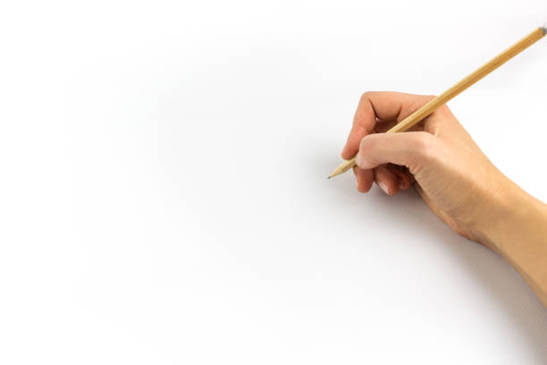 istock Hand holding wooden pencil isolated on white background 1129565163
