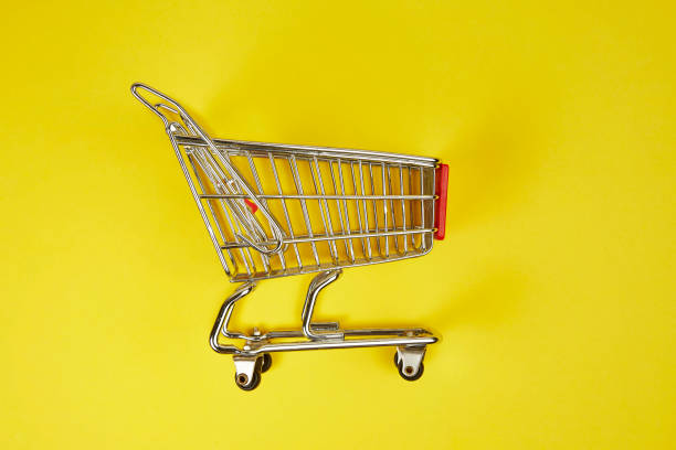 istock Shopping Cart on yellow background 1129565244