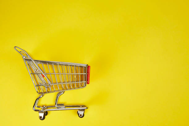 istock Shopping Cart on yellow background 1129565267