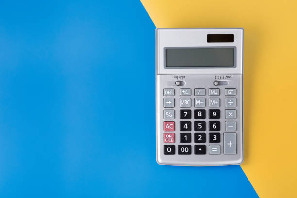 istock Sliver calculator on blue and yellow background 1129565882