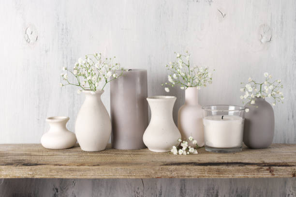 istock White flowers in neutral colored vases and candles 1129566702
