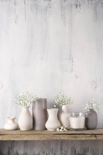 istock White flowers in neutral colored vases and candles 1129566703