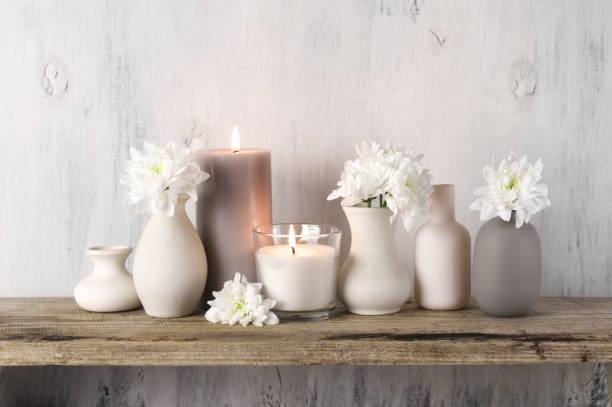 istock White flowers in neutral colored vases and candles 1129566704
