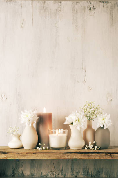 istock White flowers in neutral colored vases and candles 1129566712