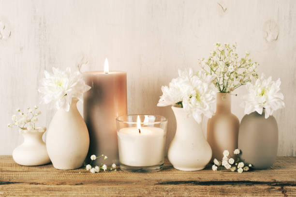 istock White flowers in neutral colored vases and candles 1129566716