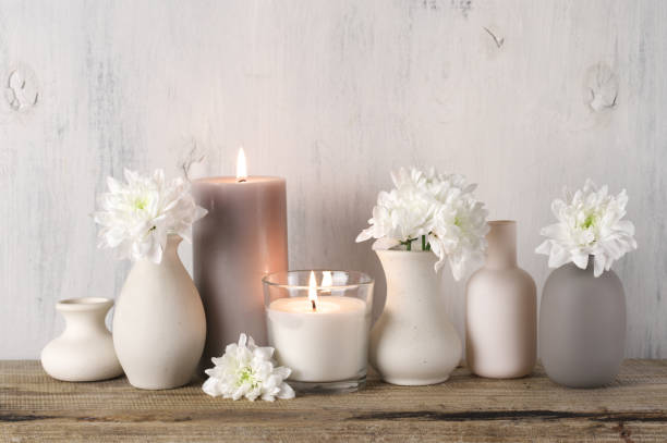 istock White flowers in neutral colored vases and candles 1129566719
