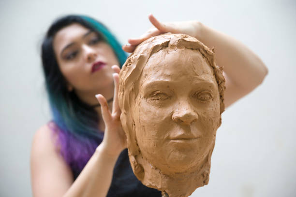 istock Artist working on clay sculpture in art studio 1129567966
