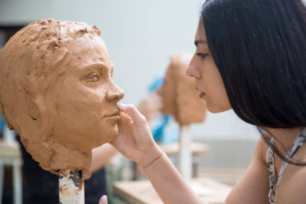 istock Artist working on clay sculpture in art studio 1129567967