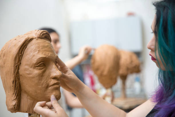 istock Artist working on clay sculpture in art studio 1129567969