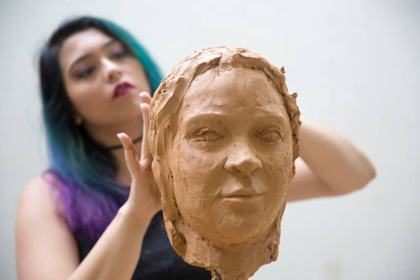istock Artist working on clay sculpture in art studio 1129567979