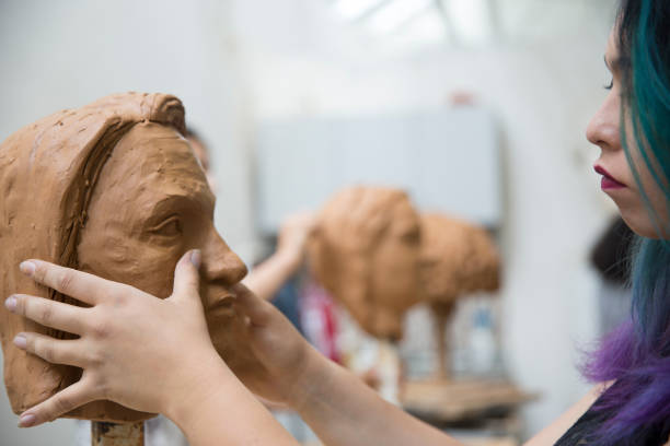 istock Artist working on clay sculpture in art studio 1129567981
