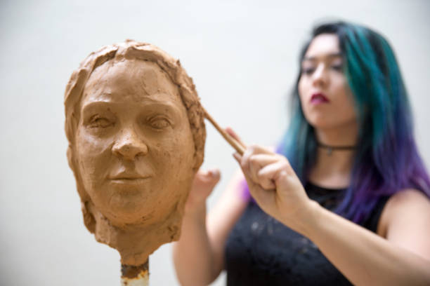 istock Artist working on clay sculpture in art studio 1129567985