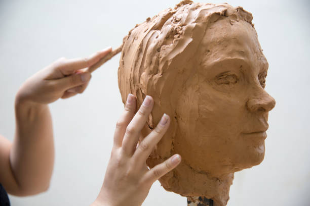 istock Artist working on clay sculpture in art studio 1129567990