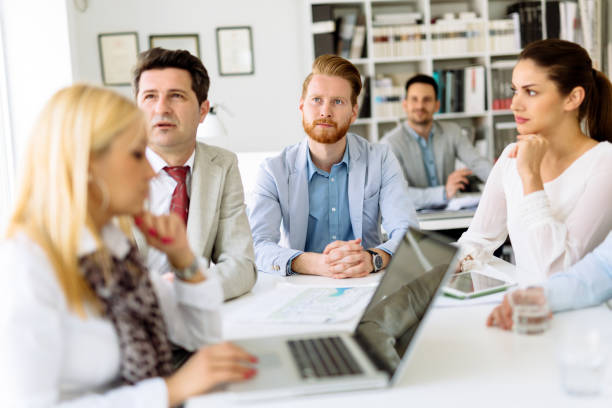 istock Group of business people working as team in office 1129572534