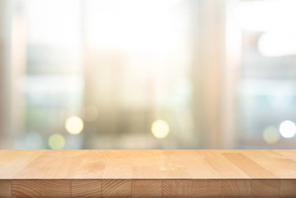 Wood table top on blur window glass,wall background Wood table top on blur window glass,wall background.For montage product display or design key visual layout background. - Image restaurant table stock pictures, royalty-free photos & images