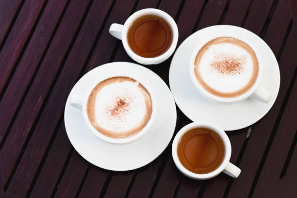istock hot coffee and tea on wood table 1129574036