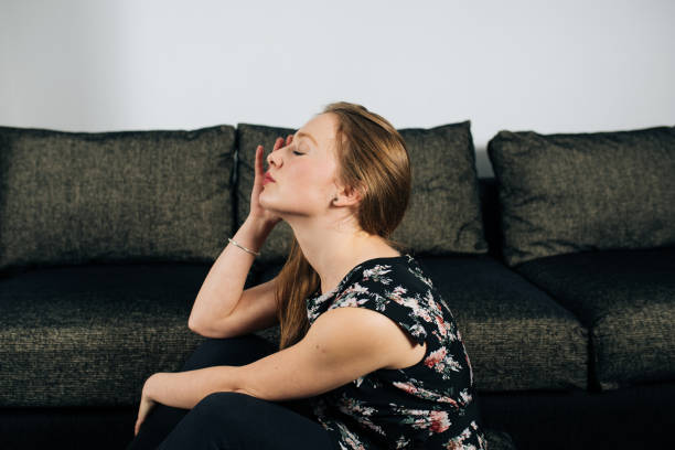 istock Alone and anxious young woman at home 1129574947