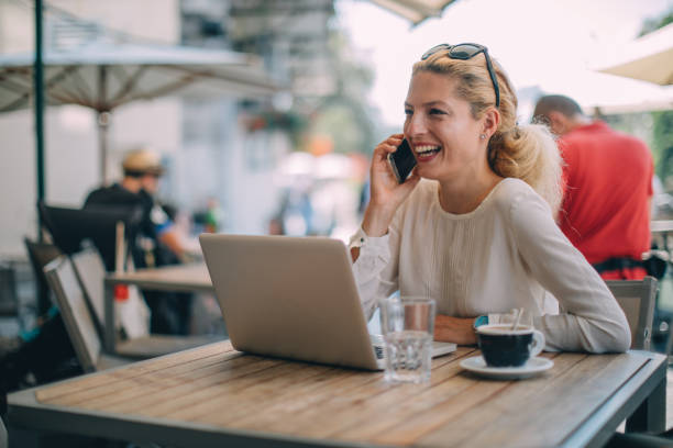 istock Woman talking on phone in cafe 1129579275