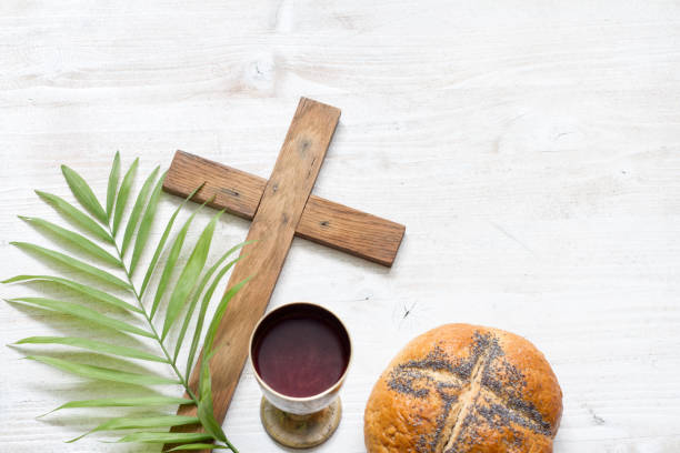 istock Cross and palm on wooden white background easter sign symbol concept 1129579331