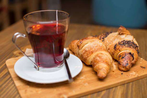 istock Cup of tea and croissants 1129580687