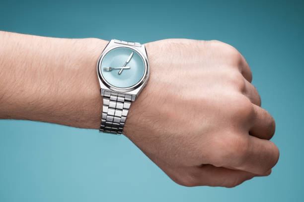 istock Wrist watch on man's hand. Plate, knife and fork on clock face. Concept of intermittent fasting, lunchtime 1129582440