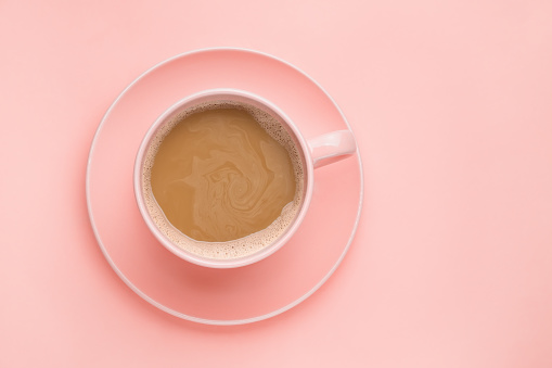 Coffee cup on pink background. Minimal concept