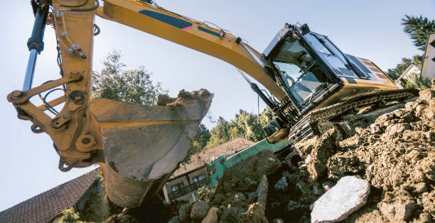 istock Excavator grabbing soil and debris at construction site 1129582683